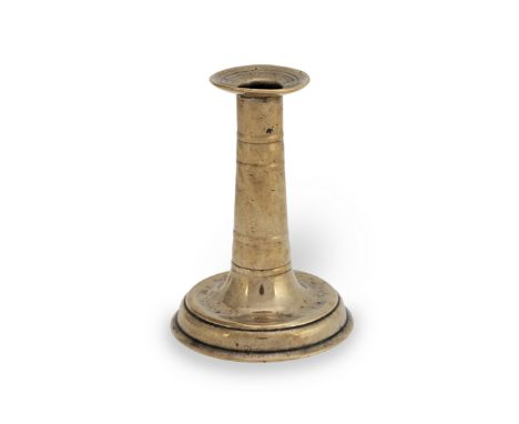 A small mid- to late 17th century brass-alloy trumpet-based socket candlestick, circa 1650-80The socket with broad flange, tw