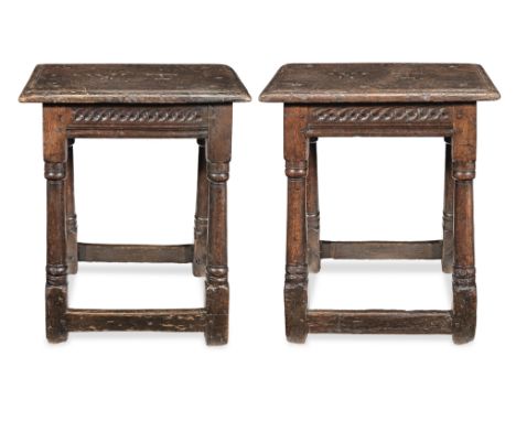 A pair of Charles I oak joint stools, West Country, circa 1640Each with triple-reeded top, centred by large carved ownership 