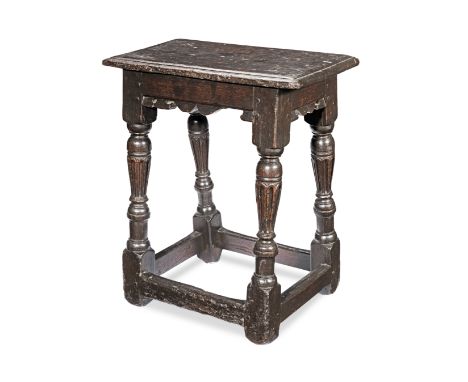 A rare and good Elizabeth I oak joint stool, circa 1580Having a double-reeded edge top, bicuspid-shaped rails, and inverted-b