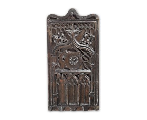 An early 16th century carved oak panel, circa 1500-20Mounted on a later oak backing, and topped by an ogee arch above delicat