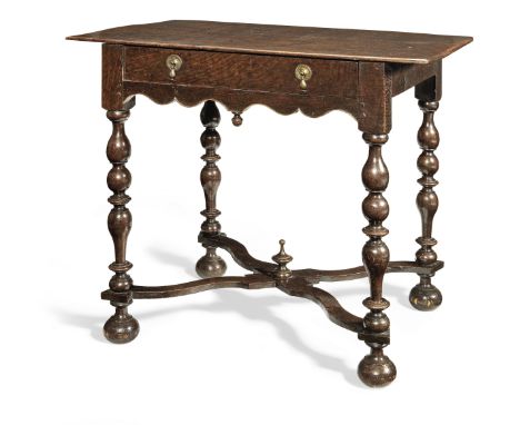 An elegant William &amp; Mary oak side table, circa 1695Having a thin one-piece top, a frieze drawer and slender double ogee-