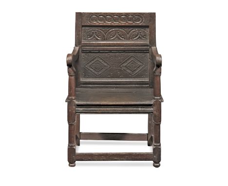 A Charles II joined oak panel-back open armchair, North Country, circa 1670 and laterThe back with a narrow lunette-carved pa