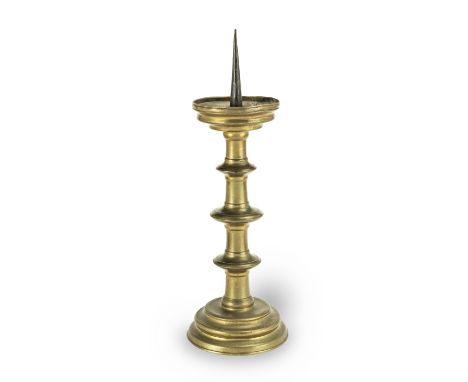 A large 17th century brass pricket candlestick, Netherlandish/FlemishTopped by a 12.5cm iron pricket secured by four rivets t