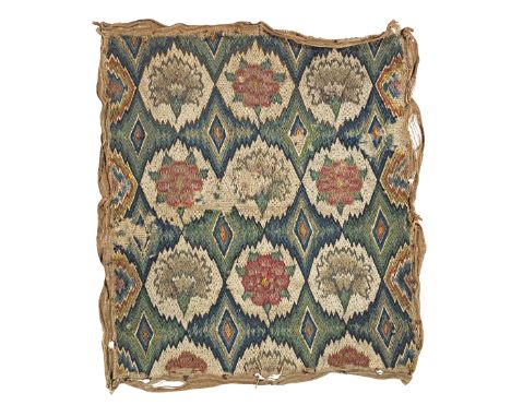 A Charles II needlework seat cover, circa 1670Designed with rows of carnations and roses within a flame-stitch surround, work