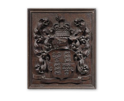 A 19th century carved walnut coat of armsThe Royal Arms of England, beneath a helm with closed visor, within foliate mantling