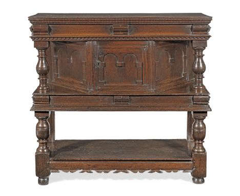 A good Charles I joined oak standing livery cupboard, circa 1640Having a box-top enclosed by two thin boards, with dentil mou