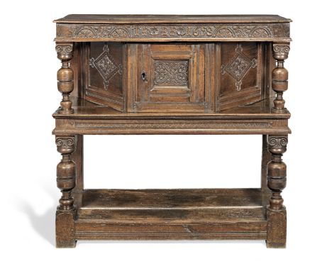 A rare and documented Commonwealth joined oak canted livery cupboard, Cumbria, dated 1658The paired top boards and undertier 