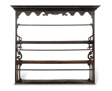 A small George III oak delft-rack, circa 1770Having a scroll-profiled frieze, and three shelves each with a retaining-bar, fl