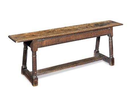 A joined oak long bench or form, EnglishCirca 1640 and laterHaving an ovolo-moulded single-piece top, and deep lower edge mou