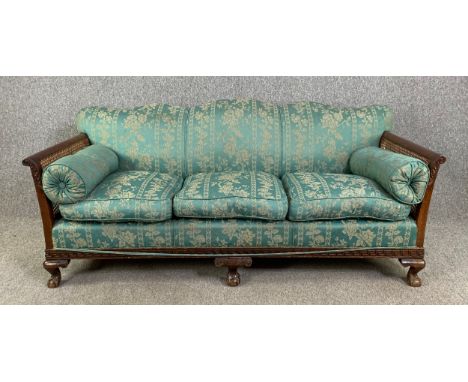 An early 20th century mahogany framed bergère sofa on carved ball and claw cabriole supports. H.79 W.190 D.80cm