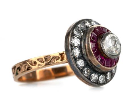 RUBY AND DIAMOND TARGET RING, set with a central rose cut diamond within a halo of rubies and a further halo of diamonds, wit
