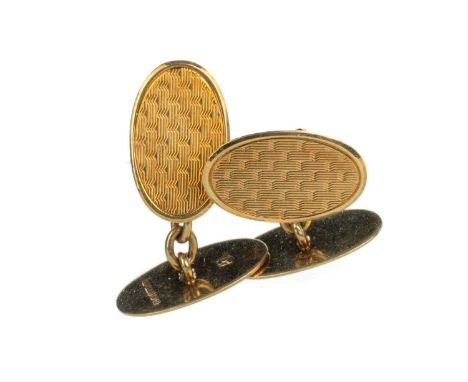 PAIR OF GOLD CUFFLINKS, with engine turned decoration to each oval panel, in fifteen carat goldQty: 6.9g