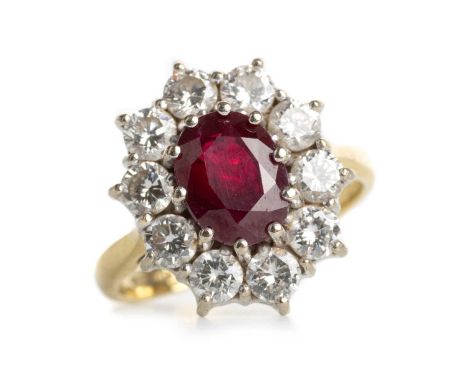 RUBY AND DIAMOND CLUSTER RING, EIGHTEEN CARAT GOLD the central oval ruby within a halo of round brilliant cut diamonds totall