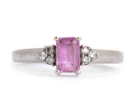 PINK SAPPHIRE AND DIAMOND RING, set with a central step cut pink sapphire, flanked by small diamonds on each shoulder, marked