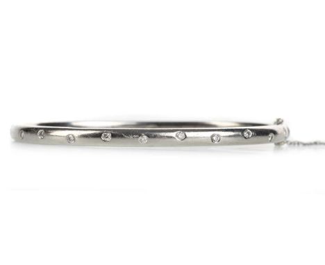 TIFFANY AND CO, ETOILE DIAMOND BANGLE with countersunk round brilliant cut diamonds, in platinum, with safety chainQty: 35.1g