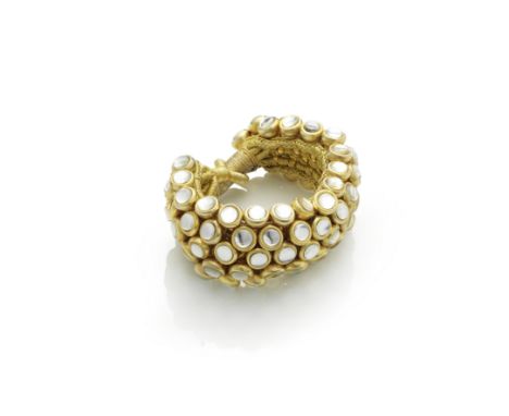 SHAKIRA CAINE: GEM-SET BEAD-LINK BRACELETOf woven gold thread, issuing a flexible ground of colourless paste finials, the cla