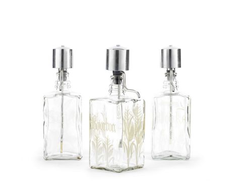 A set of three glass decanters20th centuryFor scotch, vodka and bourbon, each with a chrome pumpEach 27 cm (10 1/2 in) high,F