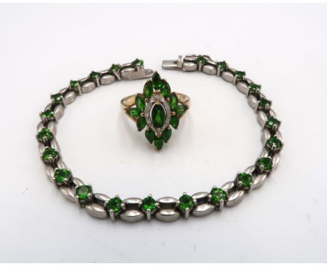 A green stone and diamond marquise cluster ring. Tests as peridot. Stamped 375. Size P 1/2. Weight 3.24 grams. Together with 