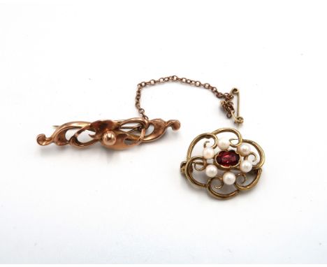 Two hallmarked 9ct yellow gold brooches - The first of scroll design, hallmarked Chester 1911 - the second of flower design s