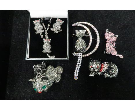 A group of Butler and Wilson Designer cat themed jewellery comprising: cat on crescent moon brooch, pink pussycat, cat earrin