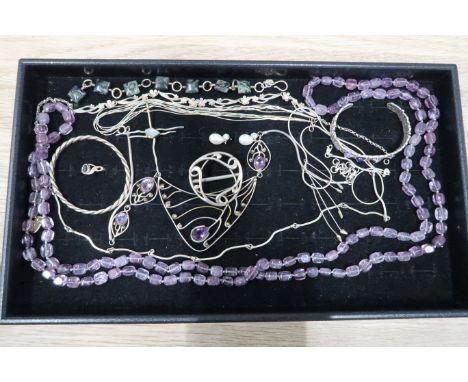 A group of silver and gem set jewellery including a silver cross pendant set with aquamarine, an amethyst set ring, beads and