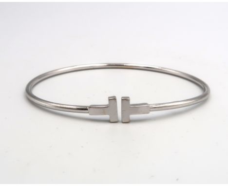 An 18ct White Gold T Bangle, Internal Diameter approx. 56mm x 52mm