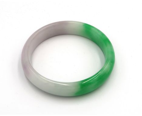 A green and white jade bangle 72mm diameter. 14mm wide. Weight 53.48 grams