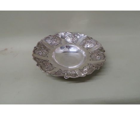 A silver bowl decorated with vine leaves, marked 925 to the centre, 7.6toz, 23cm diameter, and two a silver handled button ho