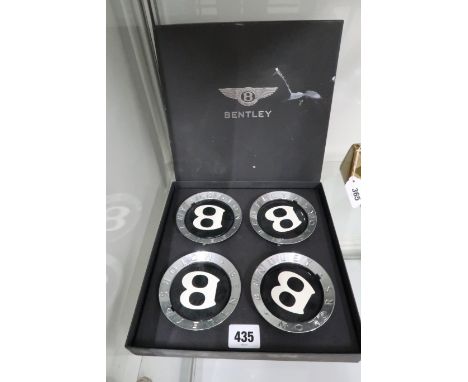 A set of four vintage Bentley Motors car wheel nut caps, good condition, boxed