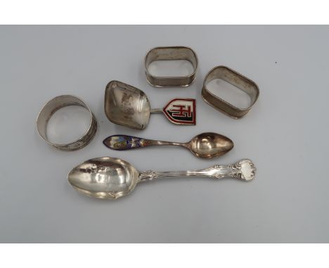 A group of silver comprising a pair of oval napkin rings with engine turned decoration, a further circular one similar, a Vic