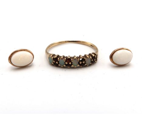 A 9ct gold opal and garnet half eternity ring. Size R 1/2. Two stones missing. A pair of oval opal ear studs. Stamped 9ct. To