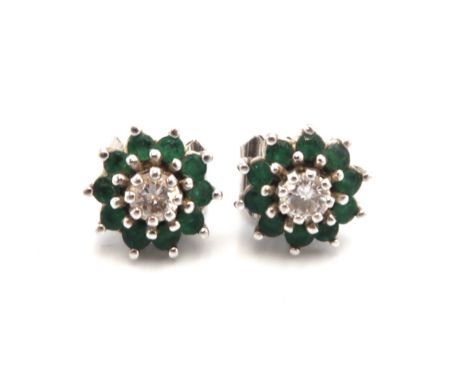 A pair of vintage 18ct white gold, diamond and emerald earrings of flowerhead form, the central diamond surrounded by ten eme