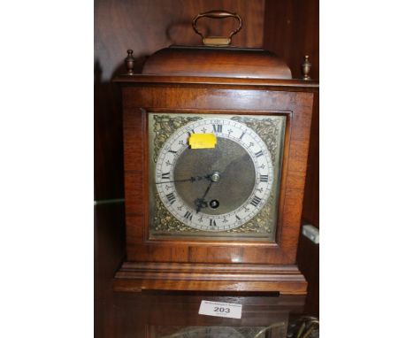 A MODERN REPRODUCTION MAHOGANY MANTEL CLOCK