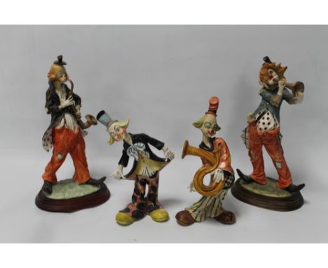 FOUR FIGURES OF CLOWNS PLAYING INSTRUMENTS 