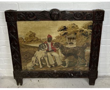 A VICTORIAN CARVED PANEL WITH NEEDLEPOINT EMBROIDERY DEPICTING AN AFRICAN GENTLEMAN SEATED WITH TWO DOGS82cm x 80cm