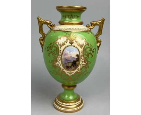 A COALPORT PORCELAIN URN WITH CENTRAL PAINTED LANDSCAPE PANEL, GILT DETAIL ON PALE GREEN GROUND21cm H