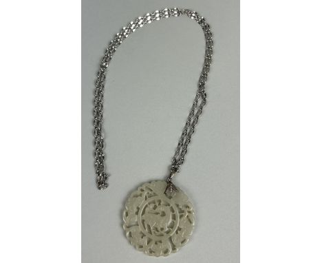 A CHINESE JADE RETICULATED DISC POSSIBLY LATE 19TH CENTURY WITH SILVER CHAINWeight: 42.1gms