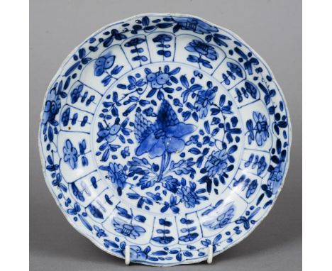 A Chinese Kangxi blue and white plate With floral decoration, the underside with blue painted mark. 21.5 cm diameter. CONDITI