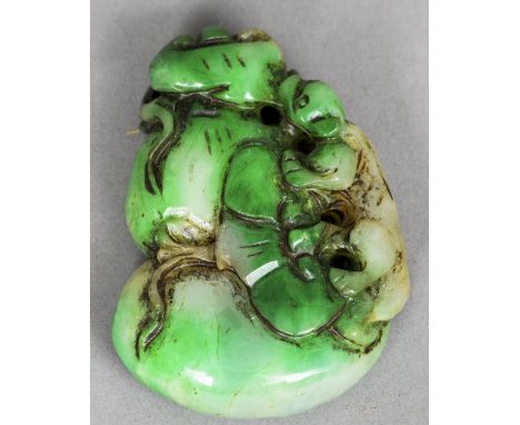 A Chinese carved jade pendant
Formed as a small animal amongst rockwork.  6.5 cm long. CONDITION REPORTS: Overall good, some 