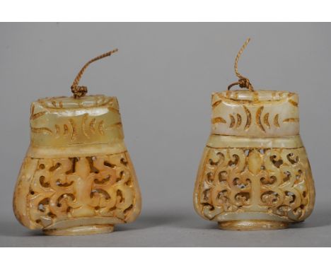 A pair of Chinese carved jade pomanders
Each with pierced baluster body and cover.  5.5 cms high.  (2) CONDITION REPORTS: Gen