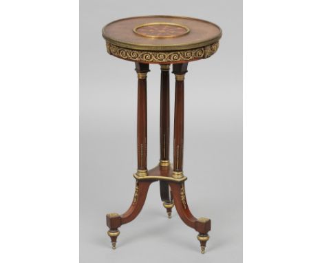 A 19th century Continental brass mounted inlaid tripod table
The inlaid circular top with scroll cast brass mounts above thre