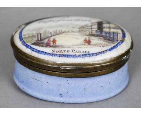 A 19th century enamel patch box
Of oval form, the hinged lid entitled A trifle from Bath, North Parade.  5 cm wide. CONDITION