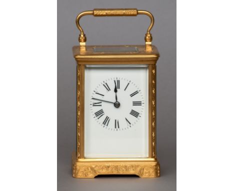 A late 19th century gilt brass cased striking carriage clock
The white enamel dial with Roman numerals, the case with engrave