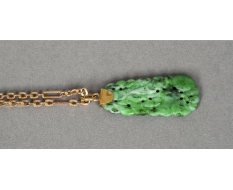 A gold mounted jade pendant 
The pierced rectangular pendant suspended on a gold chain.   The pendant 3 cms high.
