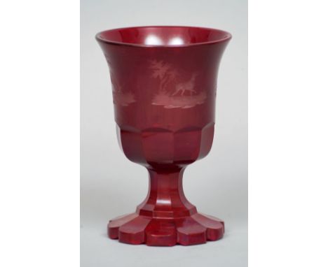 A Bohemian ruby glass goblet
Of typical form and decorated with etched hunting vignettes.  14.5 cms high. CONDITION REPORTS: 