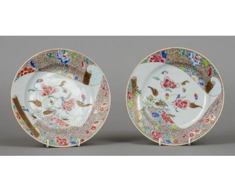 A pair of 18th century Chinese famille rose plates Each decorated with a scroll of floral decoration amongst further floral w