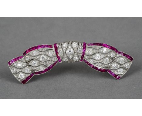 A ruby and diamond set brooch Of bow form. 5 cm wide.