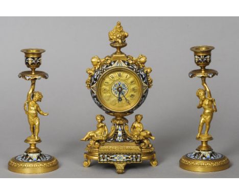 A 19th century champleve enamel decorated ormolu mantel clock garniture
The circular dial with Roman numerals above the plint