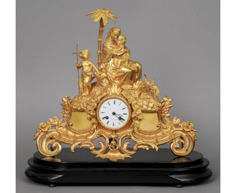 A 19th century gilt  metal mantel clock
Surmounted with the Virgin and Child and a Baptist child, the white enamel dial inscr