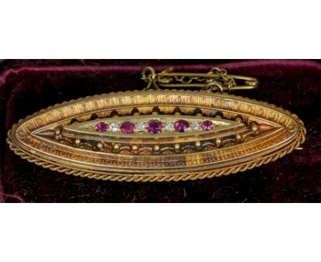 A Victorian diamond and ruby set sweetheart brooch
The verso with vacant glazed panel, indistinctly marked, cased.  5 cm wide